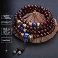 Men's rosewood prayer bracelet with 108 beads in a lapis lazuli style.