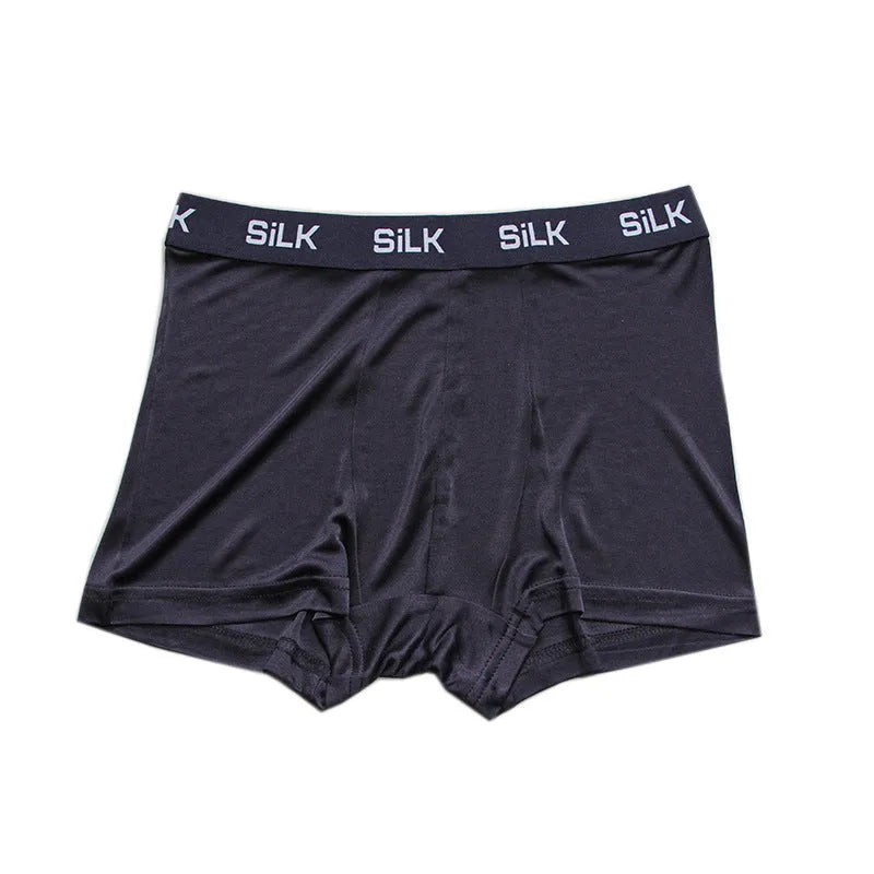 Men's loose fit silk shorts in navy blue, shown with mid waist design