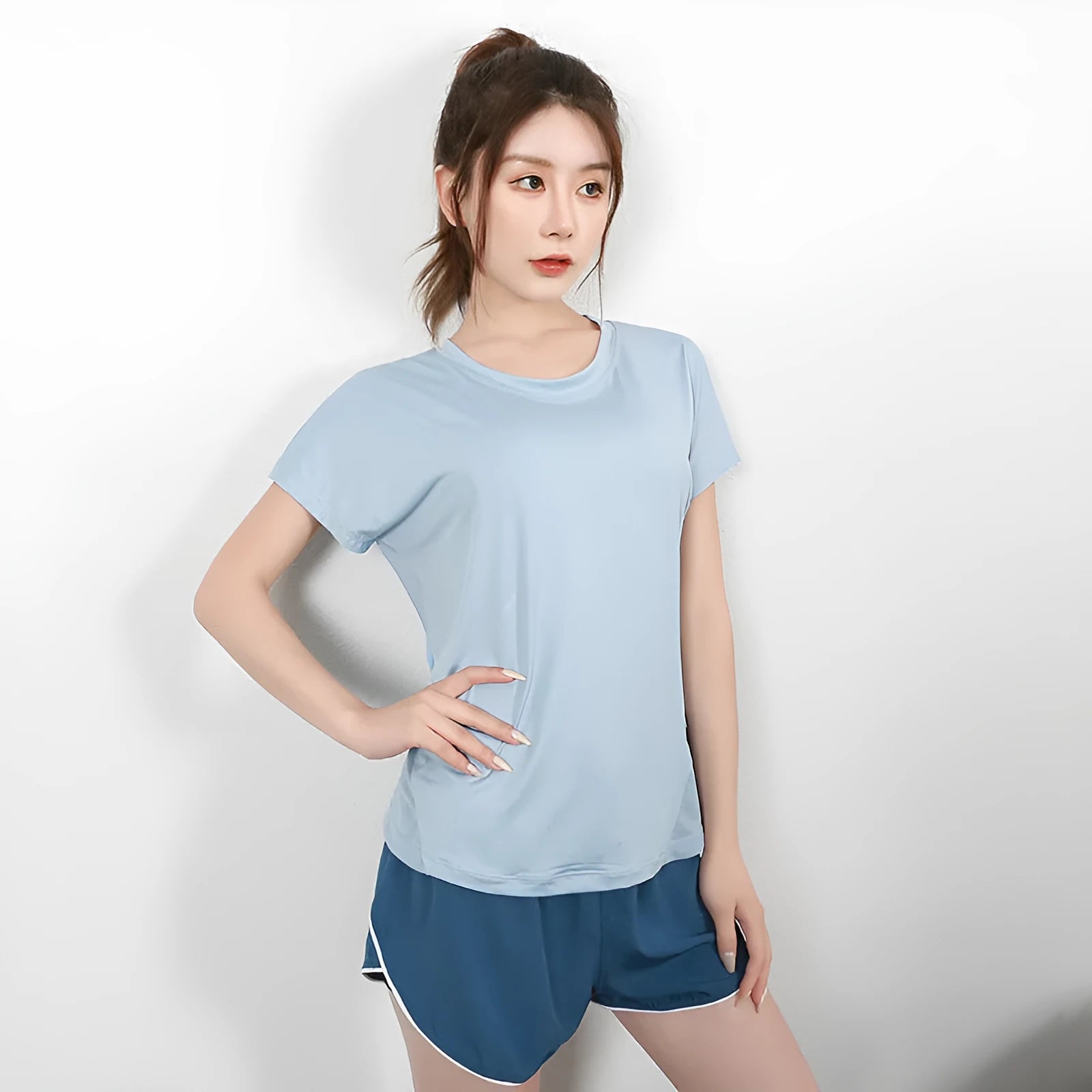 Women's short sleeve polyester sports T-shirt in black, shown flat.