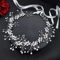 Bridal hair band with rhinestone accents on a wave-shaped alloy frame in silver and gold colours