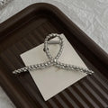 Assortment of silver metal hair barrettes and claw clips in various Korean-style designs on a white background.