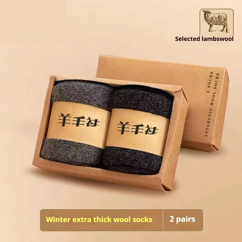Two pairs of thick merino wool winter socks in solid colours showing midsole construction