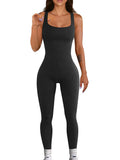 Women's black suspender tank top tights with button fastenings at shoulders showing full-length spandex construction
