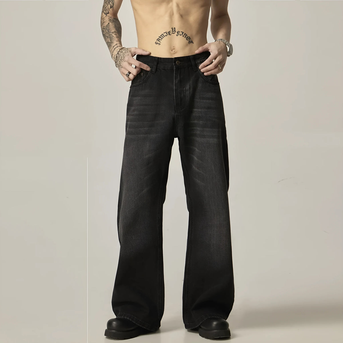 Black loose-fit straight leg denim jeans on a mannequin, showing the zip fly and retro style.