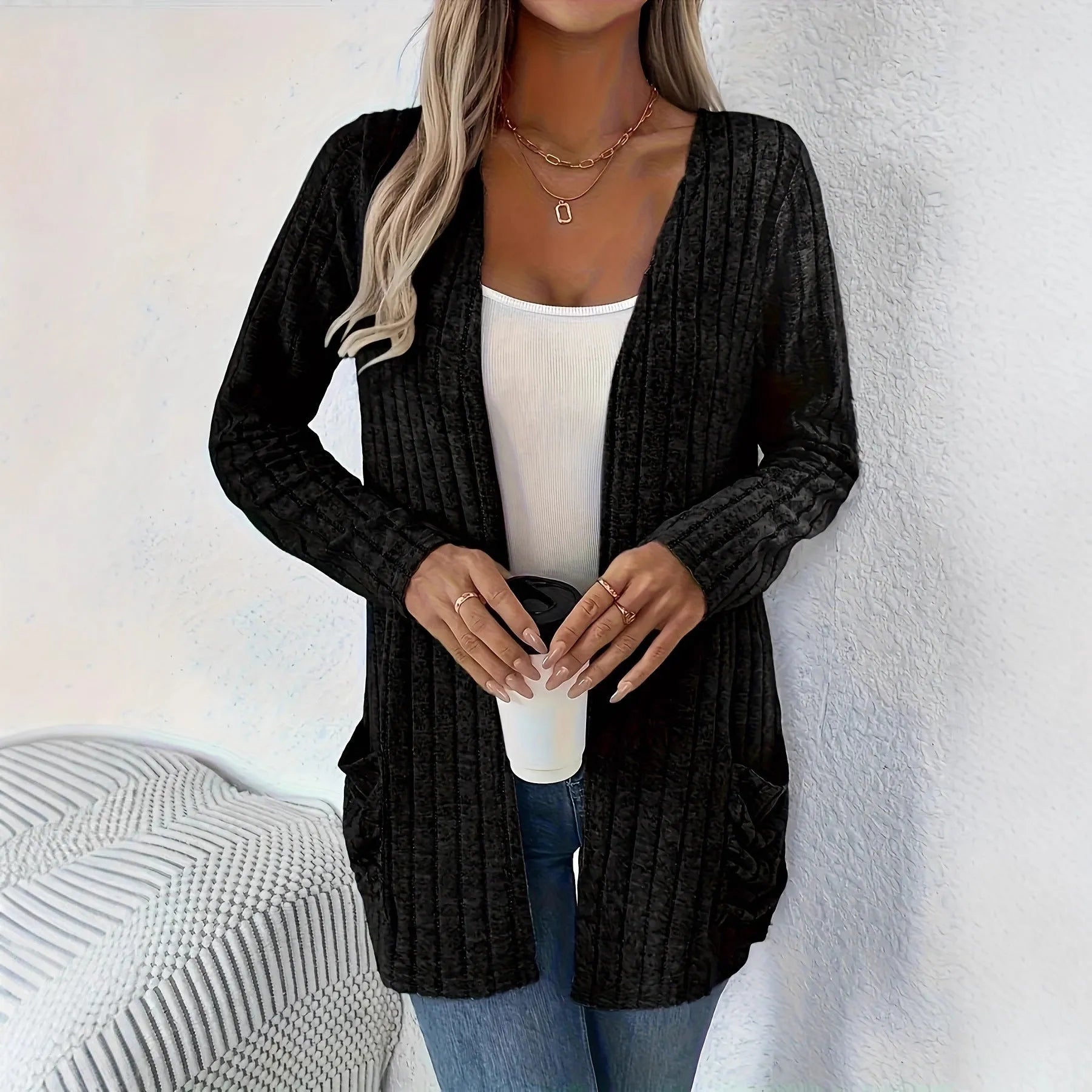 Long sleeve loose fit cardigan in grey with a pocket, shown on a hanger.