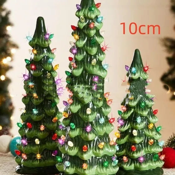 A resin Christmas tree-shaped lamp ornament with LED lights, shown in different sizes on a table.