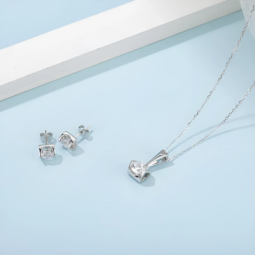 S925 sterling silver moissanite pendant necklace and stud earrings two-piece set on white background