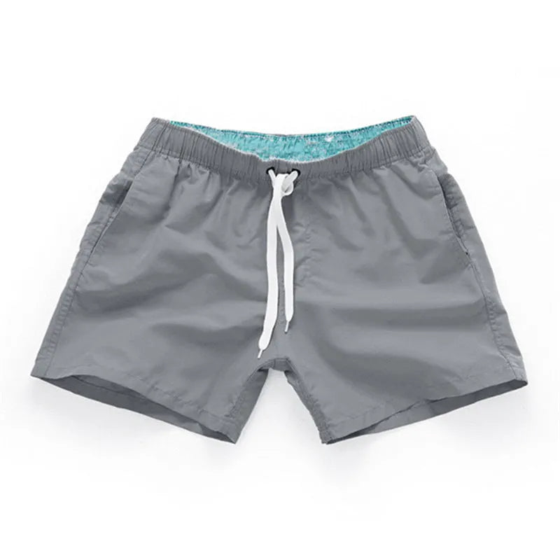 Men's straight leg beach shorts in polyester available in multiple colours and plus sizes.
