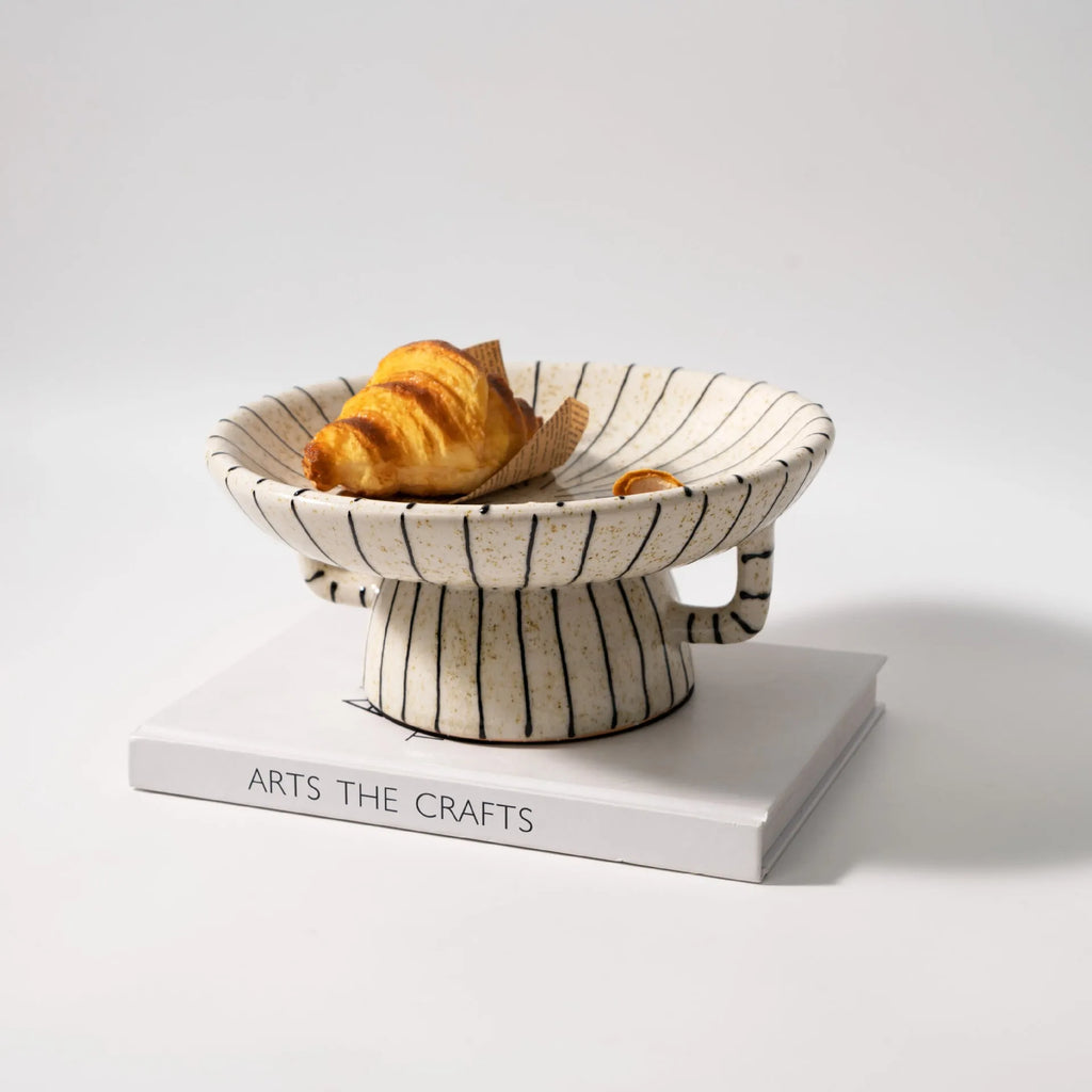 Retro style black and white striped synthetic resin fruit plate on a table.