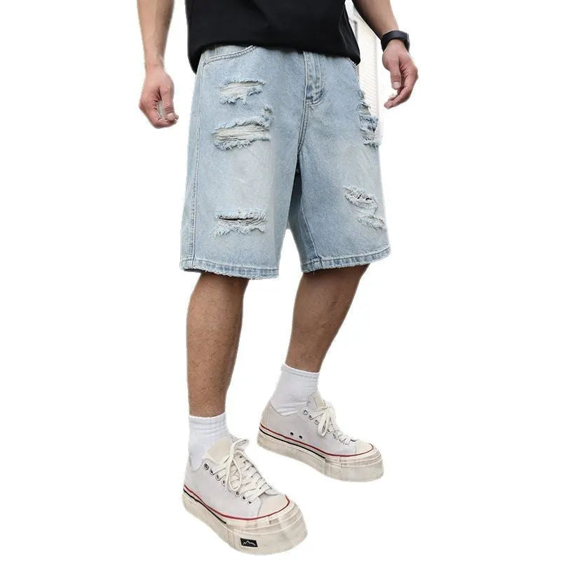 Light blue ripped denim shorts with distressed detailing and loose straight-leg silhouette
