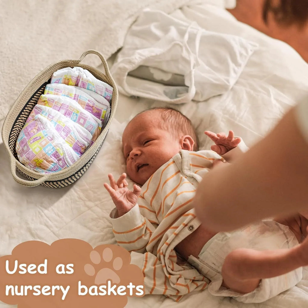 Small light beige handmade woven cotton rope storage basket with a handle on a wooden floor.