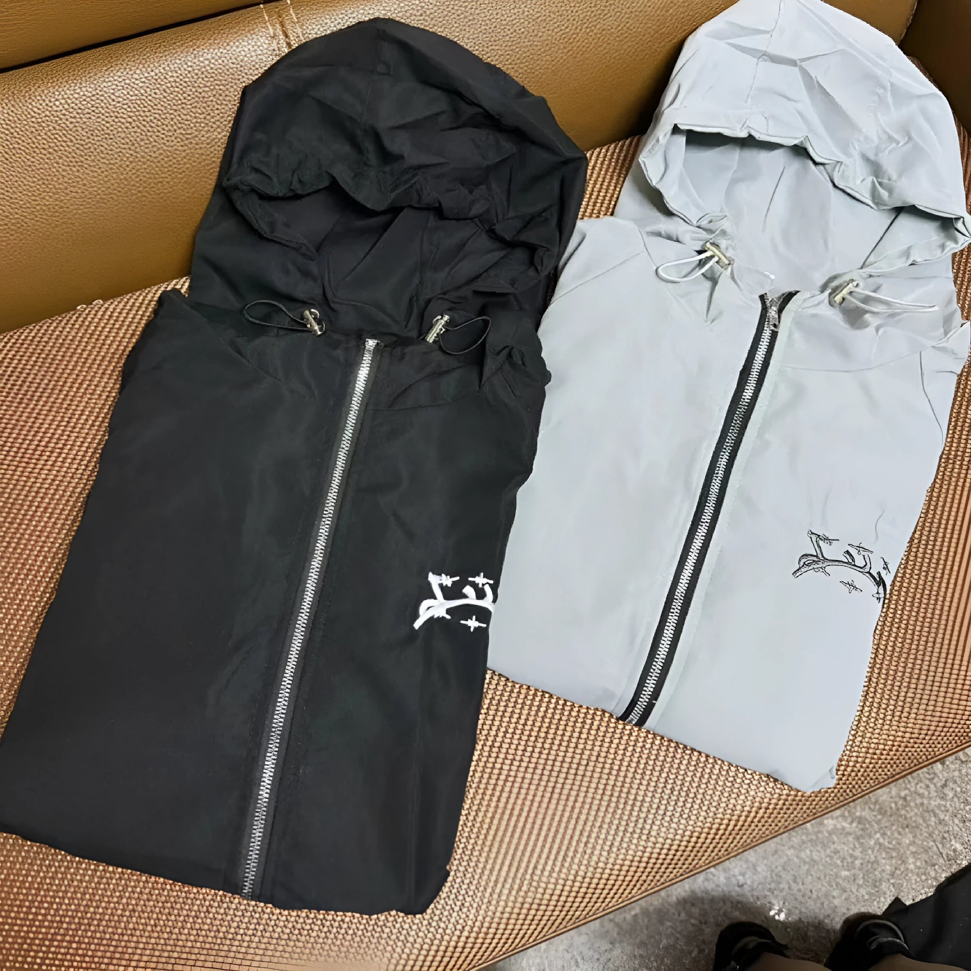 Men's loose fit hooded sunscreen jacket in polyester fabric shown in black colour with British style detailing