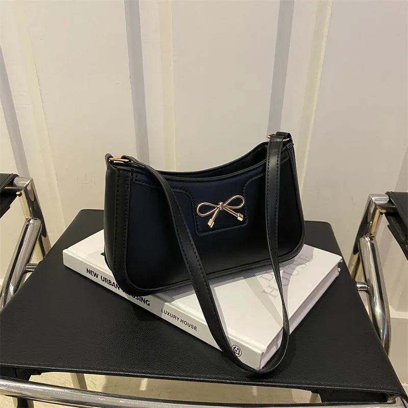 PU leather shoulder bag with bow decoration in a horizontal square shape, shown in one of six available colours.