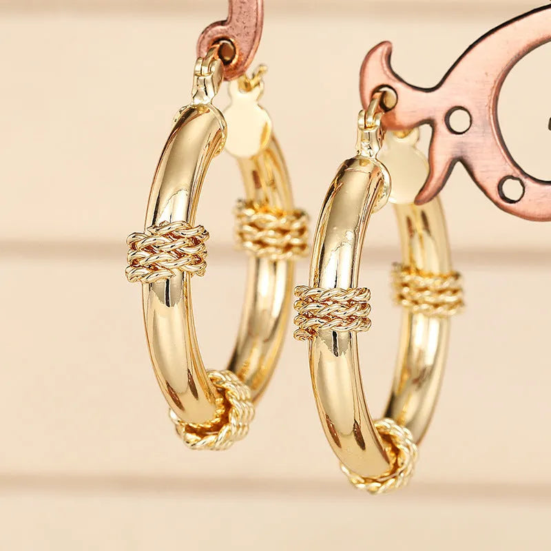 Women's geometric copper earrings with clip-on design in golden colours featuring ring and line elements