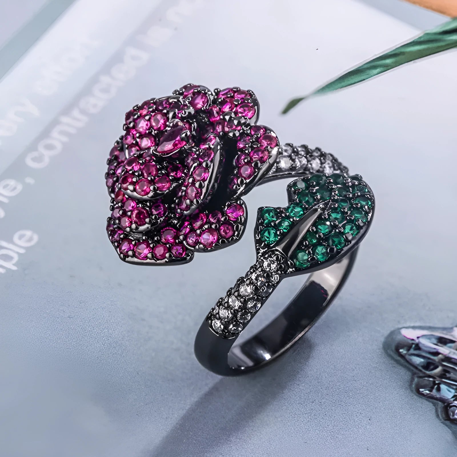 Women's geometric flower ring in black gold with simulated red corundum stone on gold-plated copper band