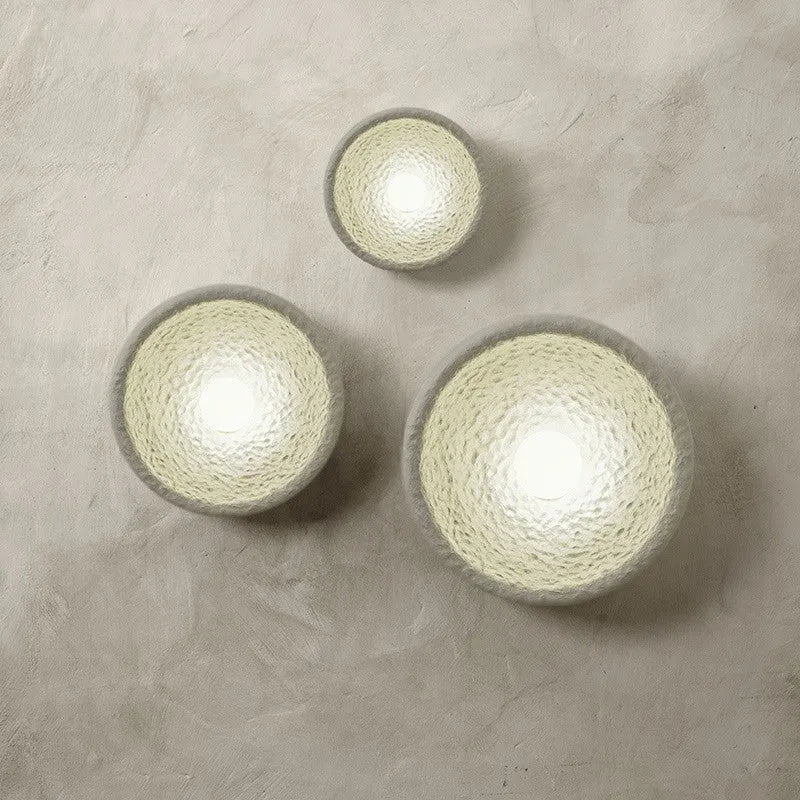 Japanese-style simple silent wall lamp with white resin shade in a modern room setting.