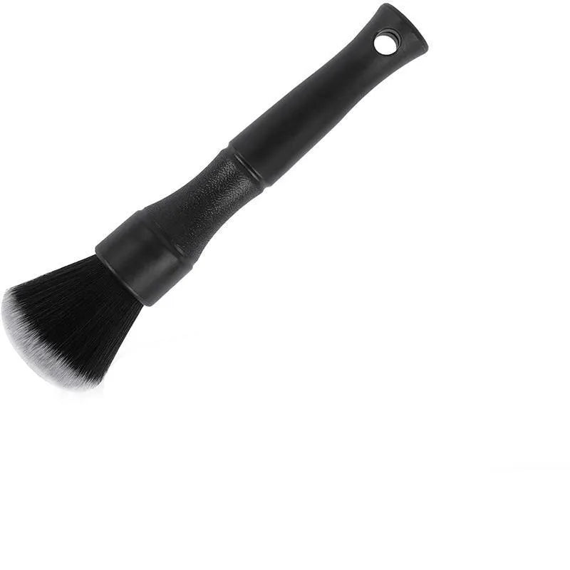 Black ultra-soft pig hair car detailing brush with PP plastic handle on a car seat.