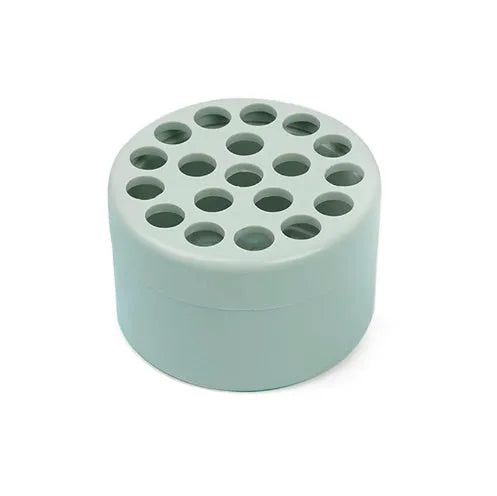 Three spiral stem brackets in green, light gray, and yellow placed on a table