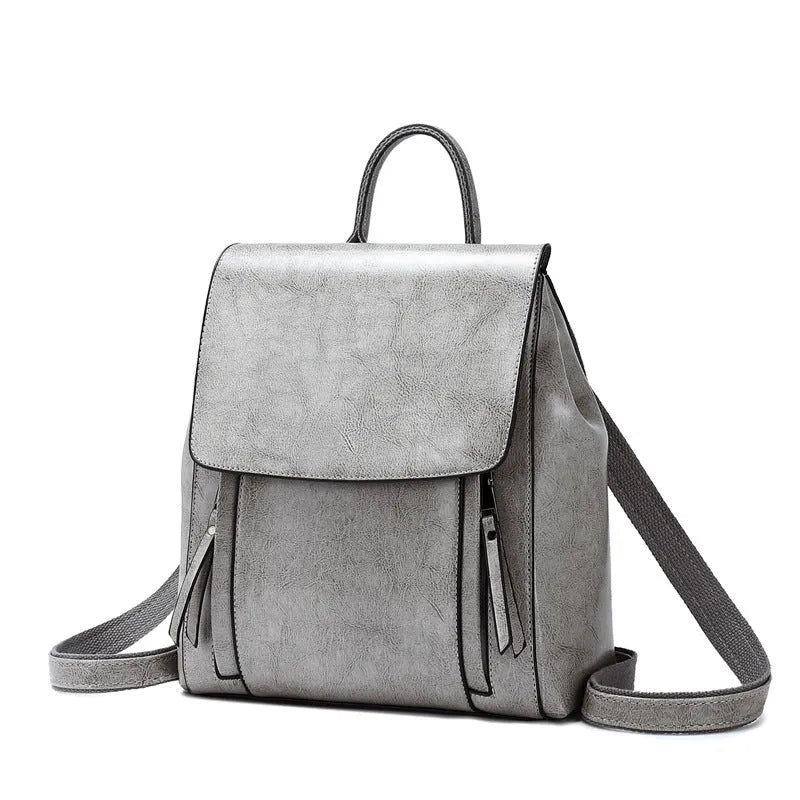 Large black genuine leather women's backpack with shoulder straps and internal organiser pockets.