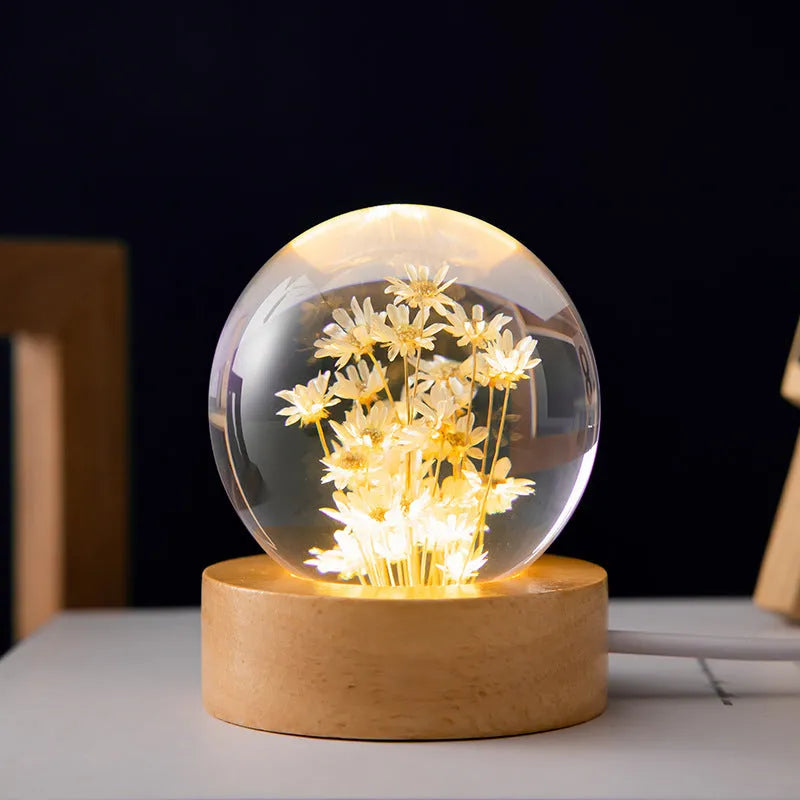 3D dandelion crystal ball LED night light on a beech wood stand, showing USB cable.