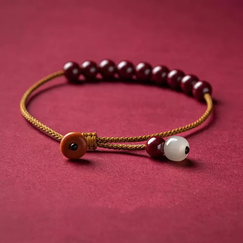 Cinnabar and Hetian jade geometric bracelet with hand-woven construction