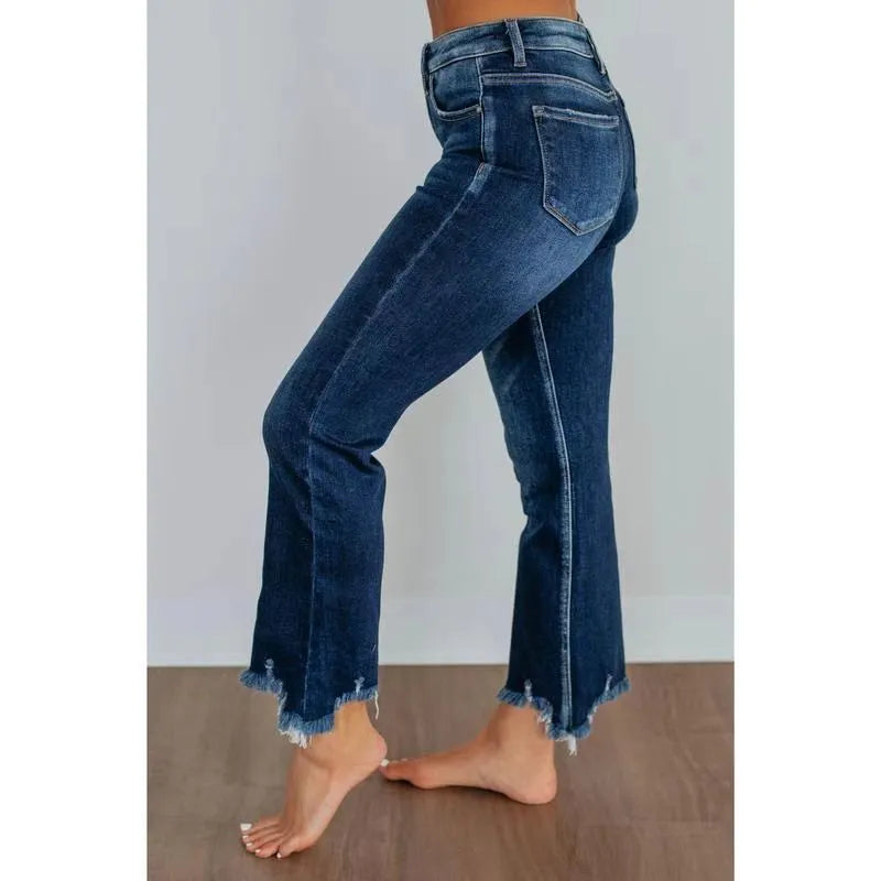 Women's solid colour cotton denim jeans with a hand-worn finish in dark blue.
