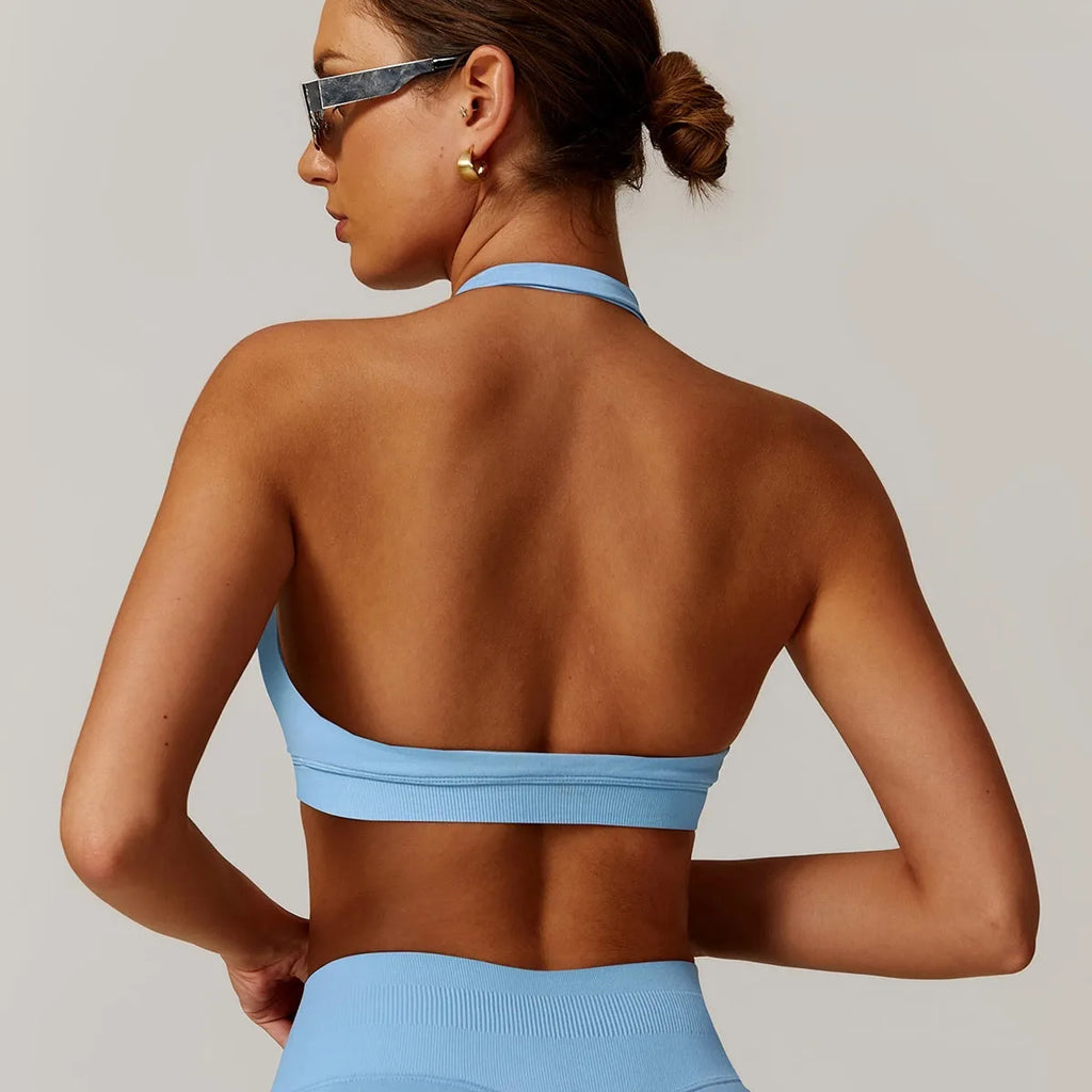 Women's black halter neck sports bra with hollow cutout design and medium support for yoga