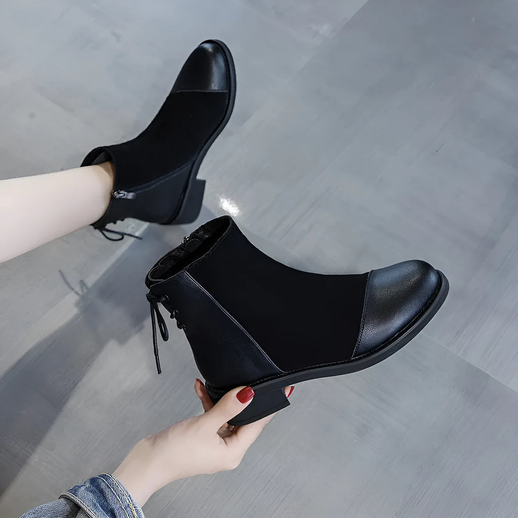 Black women's side-zip Martin boots with a round toe and short heel on a non-slip sole.