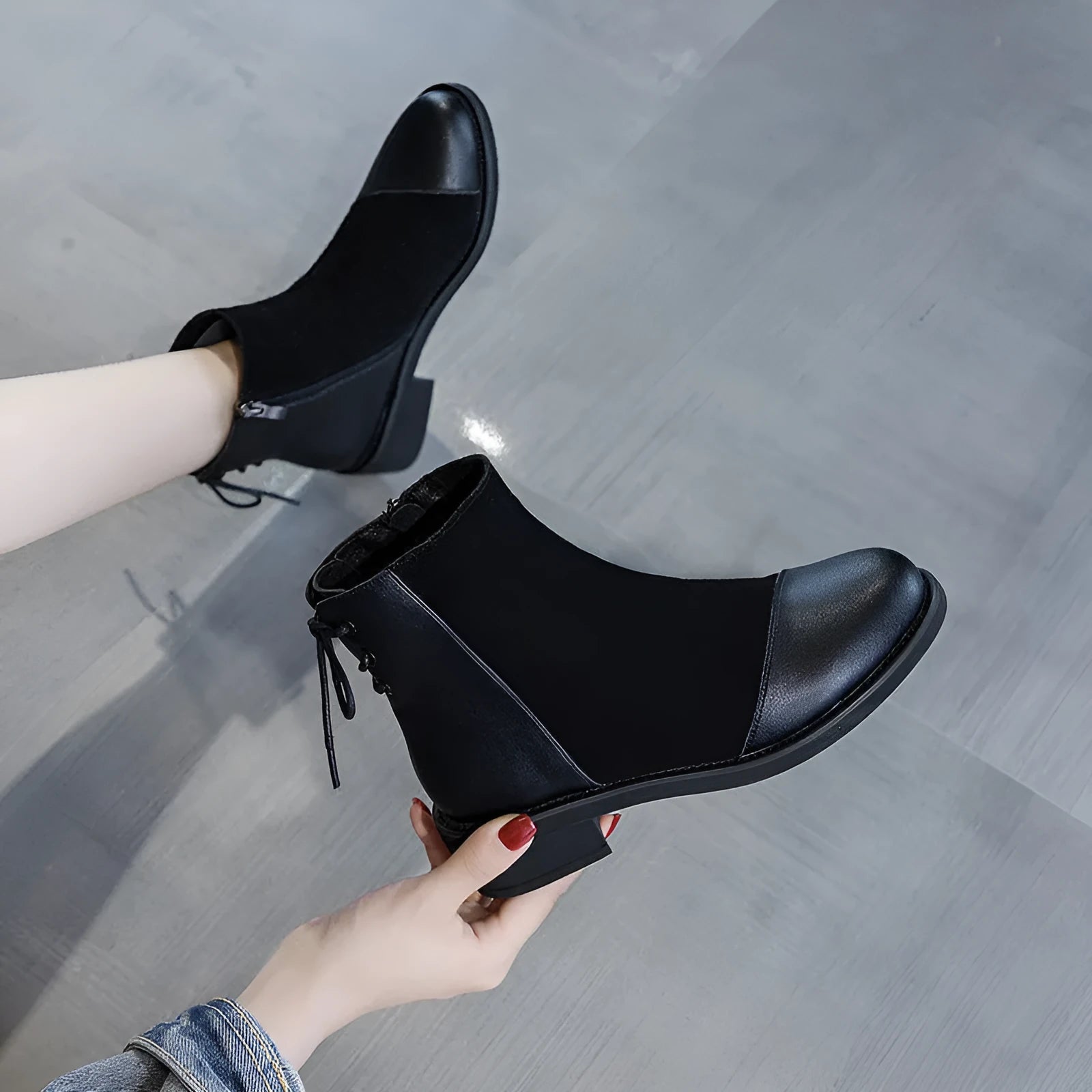 Black women's side-zip Martin boots with a round toe and short heel on a non-slip sole.
