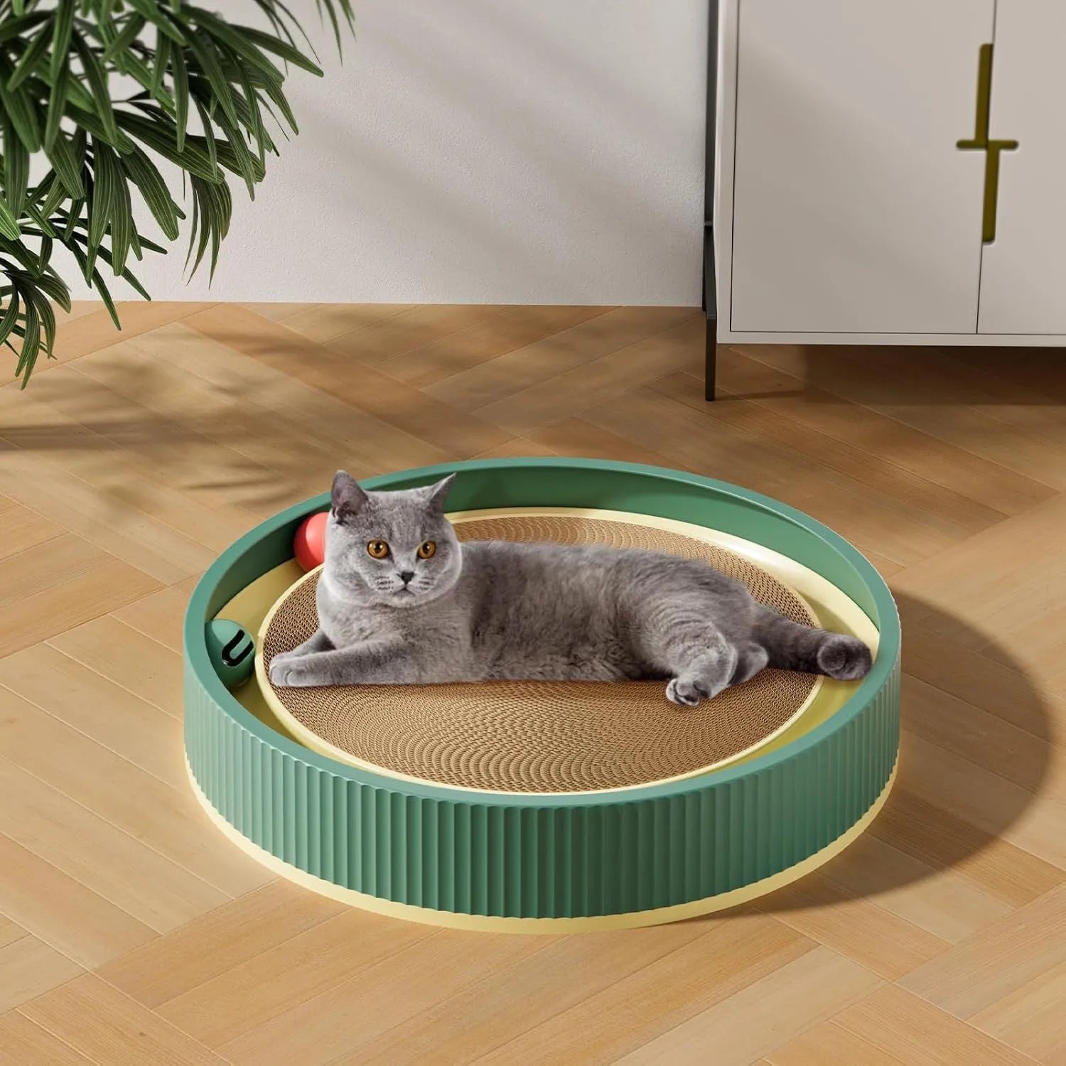 Large green cat scratching board with interactive ball toys showing refillable core design