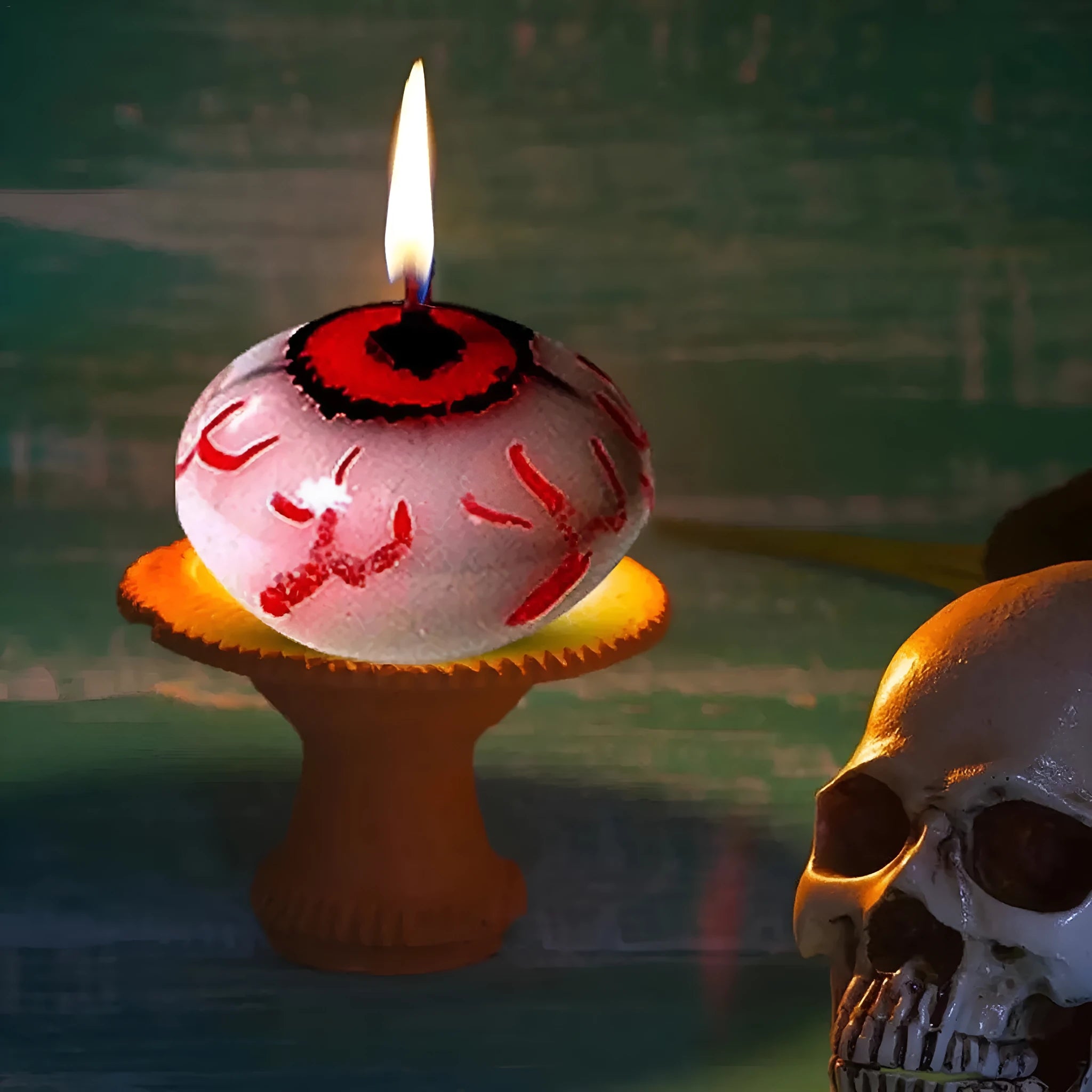 Red oval eyeball floating Halloween candle made from paraffin wax