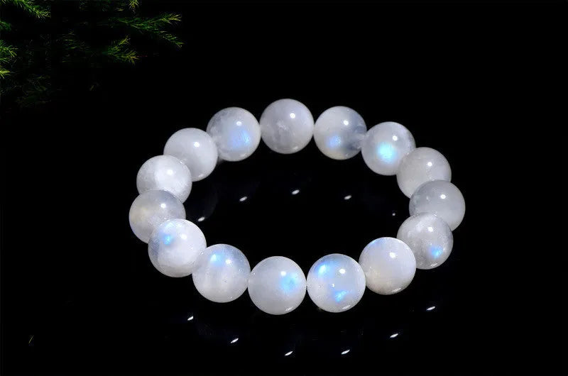 Natural blue moonlight round bead moonstone bracelet with geometric shape on a wrist.
