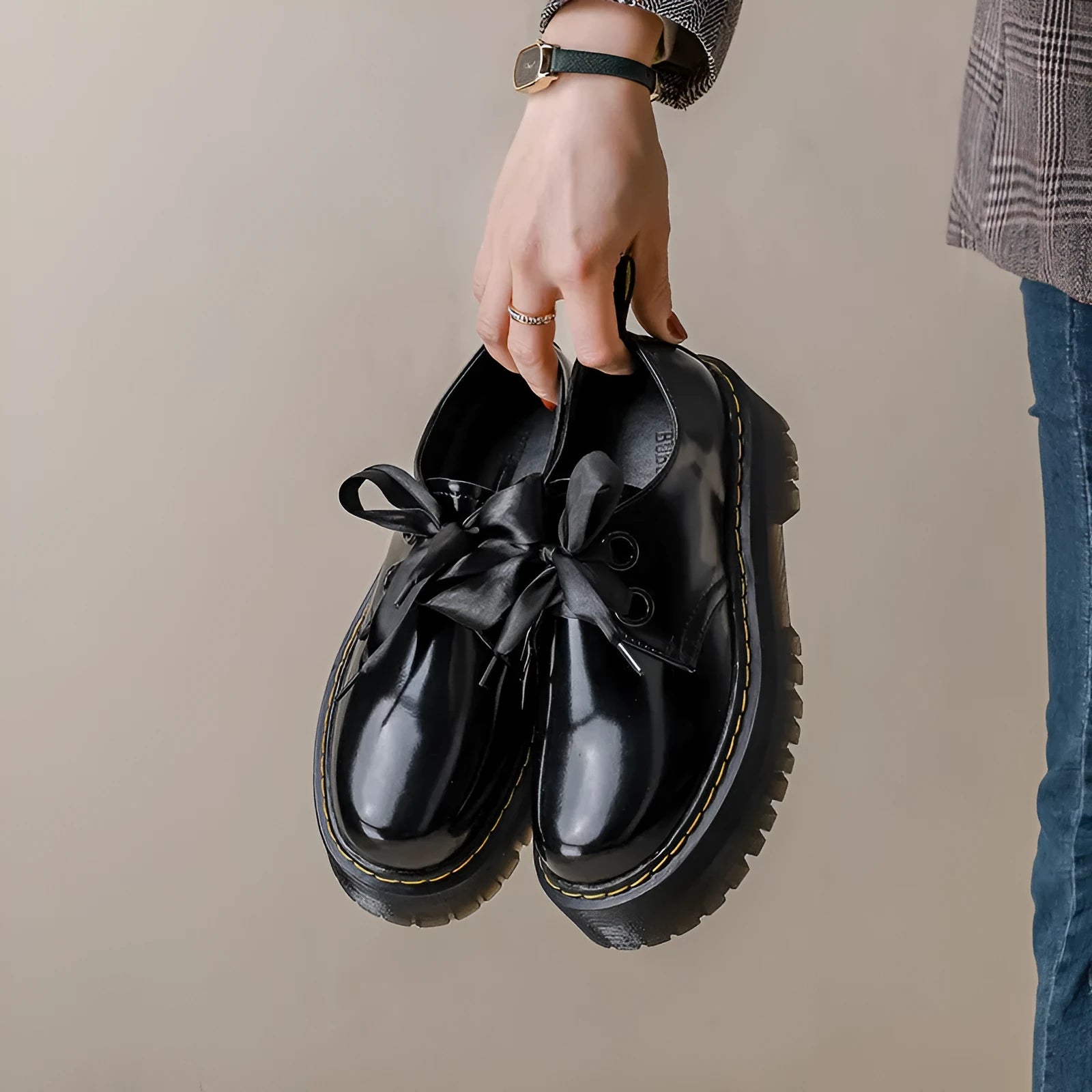 Black women's thick soled lace-up shoes with ribbon and cross strap detail on a superfine fibre upper.