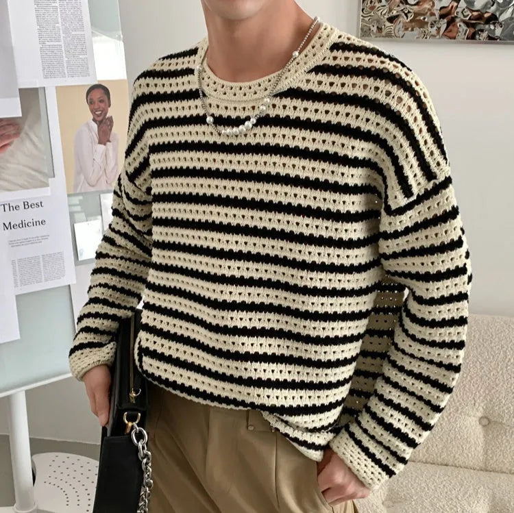 Men's black cotton blend long sleeve loose fit sweater on a hanger, front view