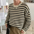 Men's black cotton blend long sleeve loose fit sweater on a hanger, front view