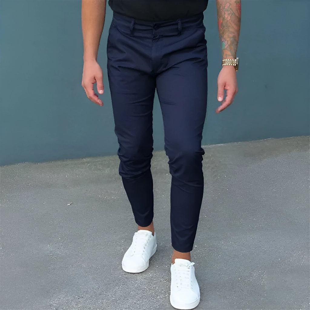 Men's pure color tight trousers in black, side view, showing mid waist and micro-elastic polyester fabric.