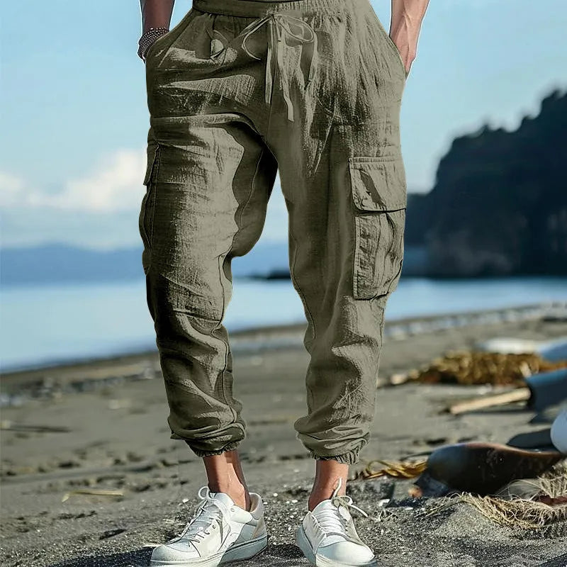 Men's solid colour linen casual trousers with ankle ties and a drawstring waist.