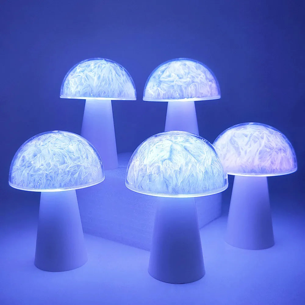 Small white mushroom-shaped night light with colourful RGB glow on a wooden table.