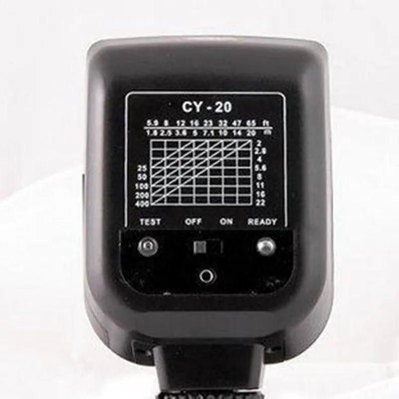 A compact black hot shoe flashgun for DSLR cameras, shown tilted upwards on its mount.