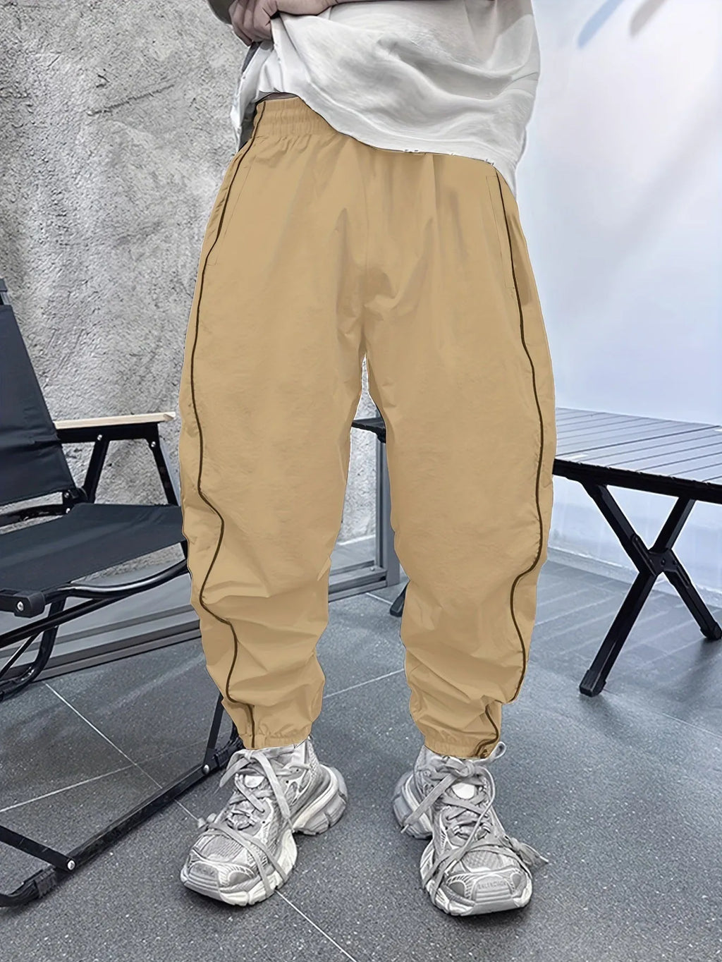 Men's loose fit cropped sports trousers in bamboo fibre fabric shown in army green colour.
