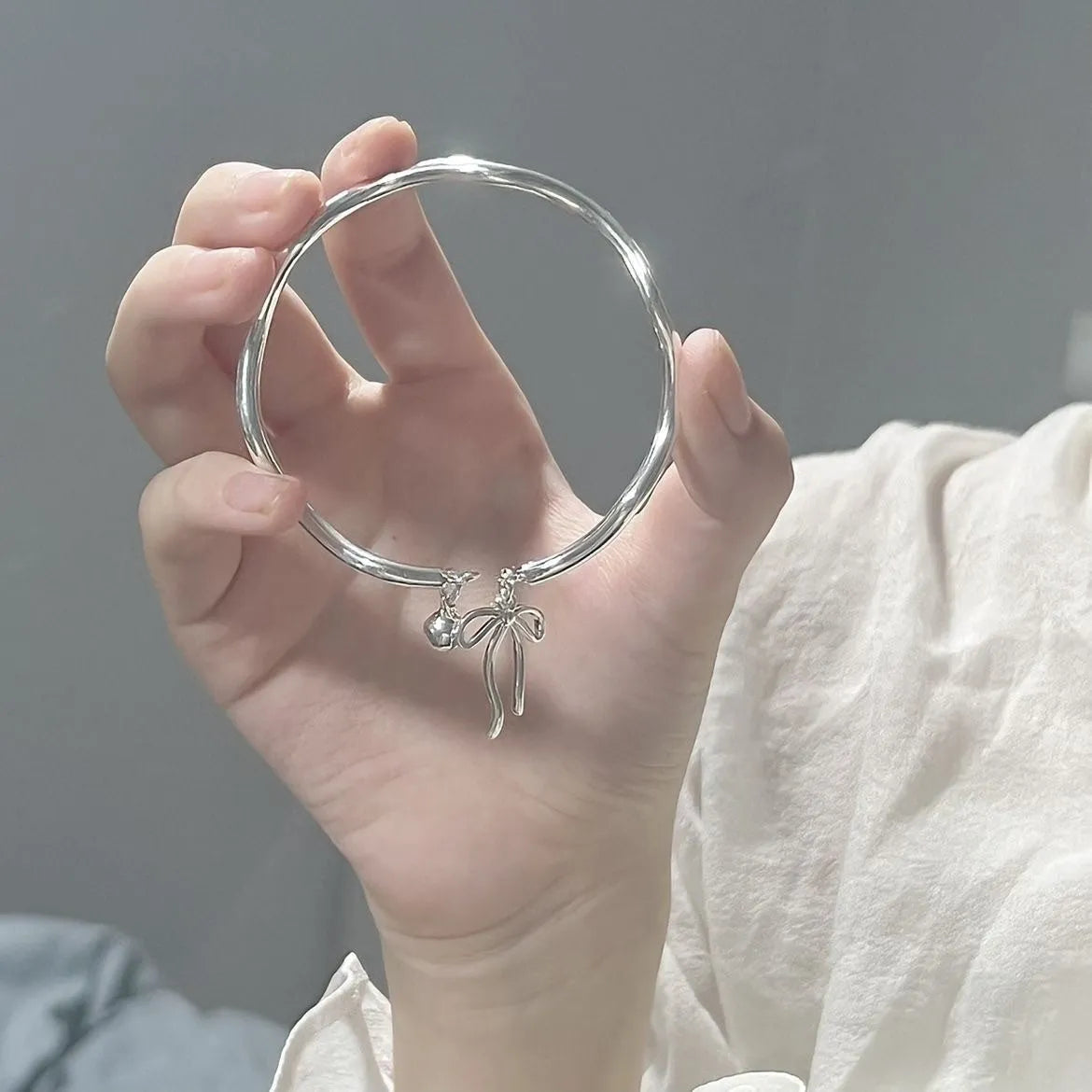Silver adjustable bow bell opening bracelet made from zinc alloy