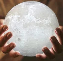 3D printed white moon lamp with detailed craters on a wooden stand, showing touch ring at base