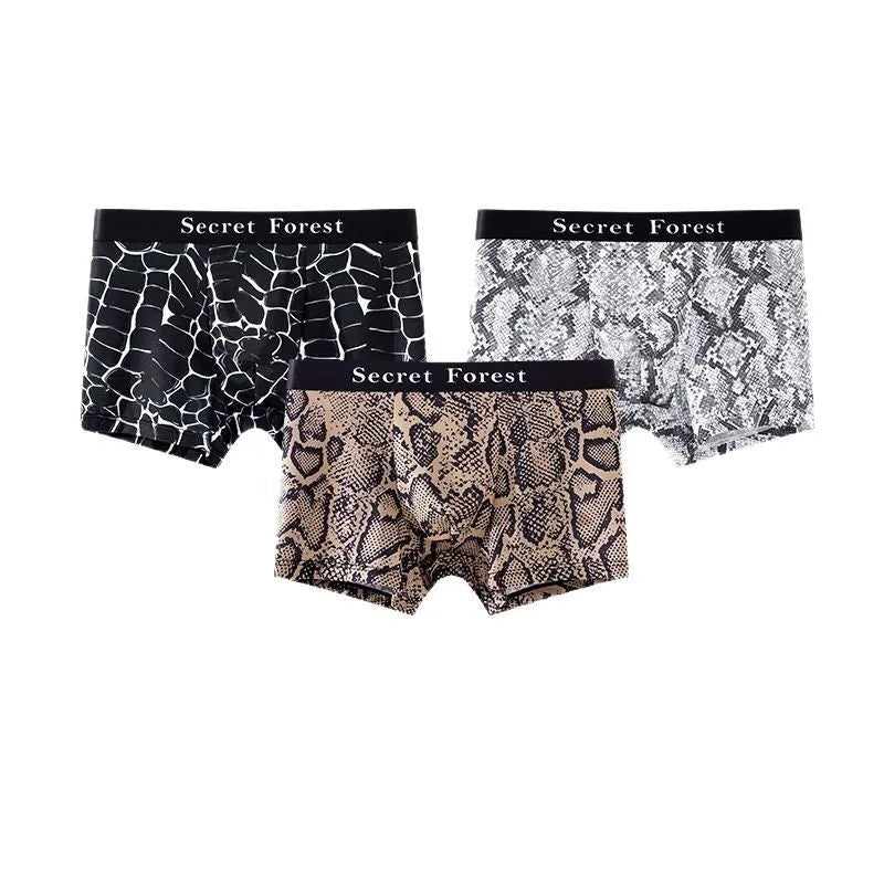 Men's thin loose polyester boxer shorts in black on grey background showing mid-waist design