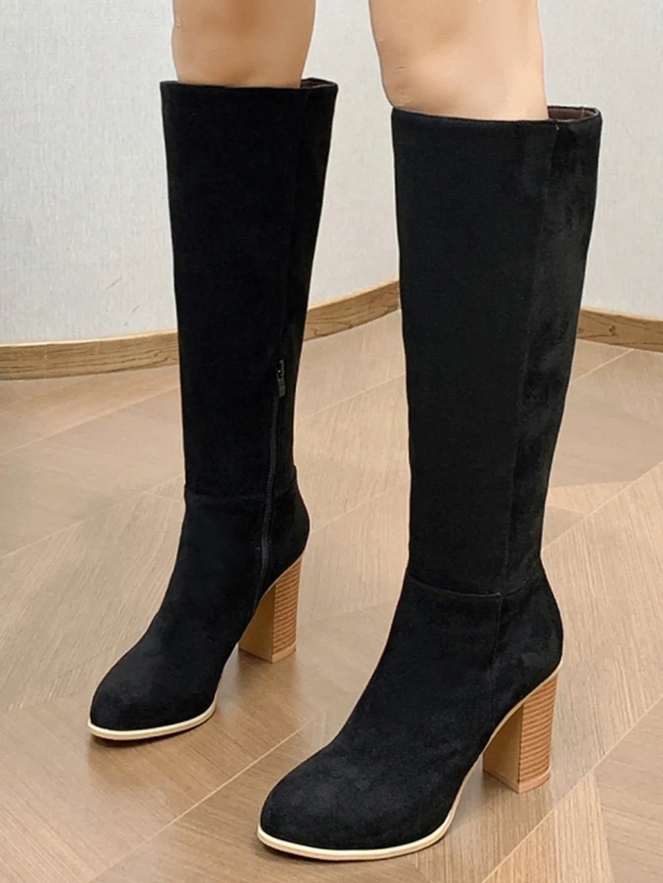 Women's black square toe high heel fashion boot made of artificial PU material.