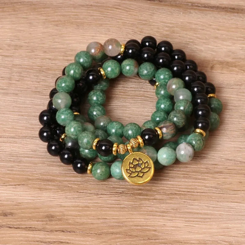 Green and black alloy elastic beaded bracelet showing alternating colours on wrist