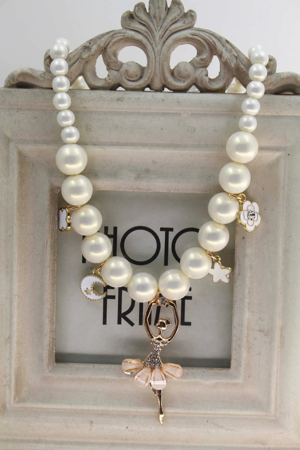 Children's Korean style pearl necklace in Symphony Pink, laid flat on white background