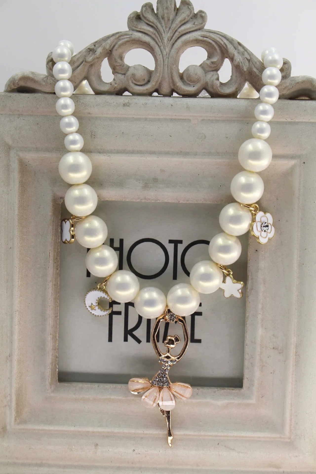 Children's Korean style pearl necklace in Symphony Pink, laid flat on white background