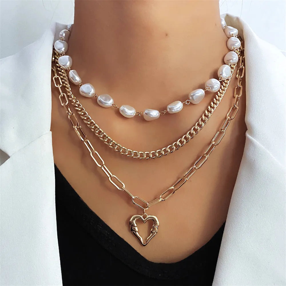 Gold electroplated vintage necklace with heart-shaped pendant on an adjustable pearl-style chain.