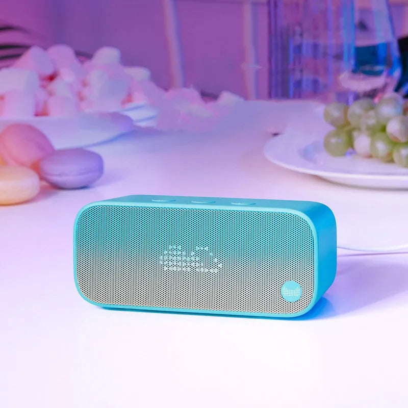 Elf Sugar Cube AI Smart WiFi Speaker in blue, green, red, or white colour on a desk.