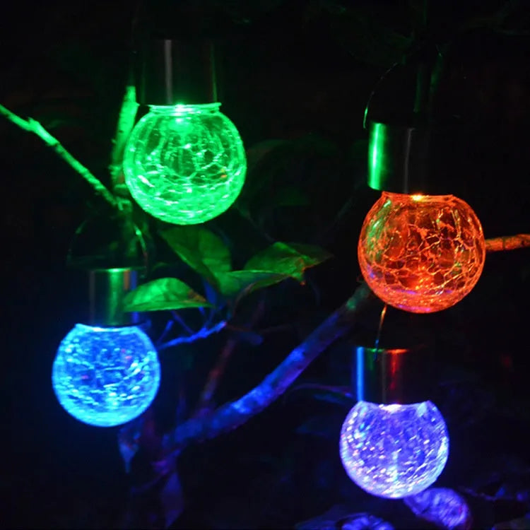 Solar cracked glass pendant light with rubber body and LED glow in garden setting
